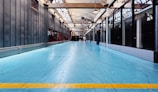 A large room with a blue floor and a yellow line