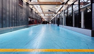 A large room with a blue floor and a yellow line