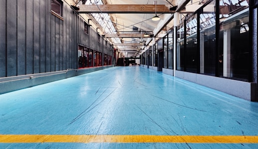 A large room with a blue floor and a yellow line