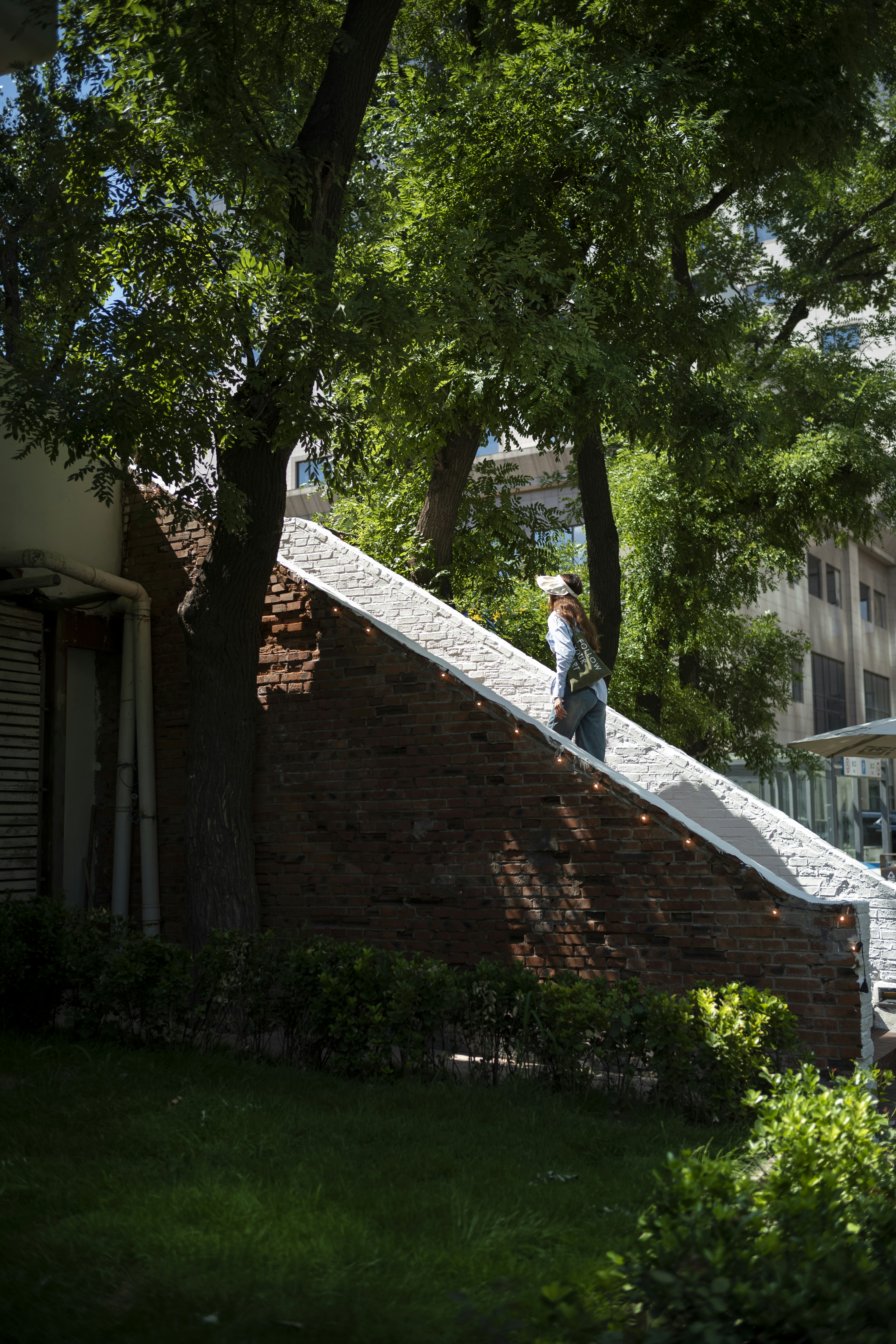 A homeowner taking photos of a damaged roof after a storm