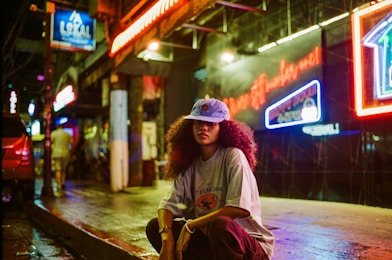 A person sitting on a skateboard on a city street