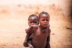 A couple of kids standing next to each other