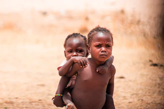 A couple of kids standing next to each other