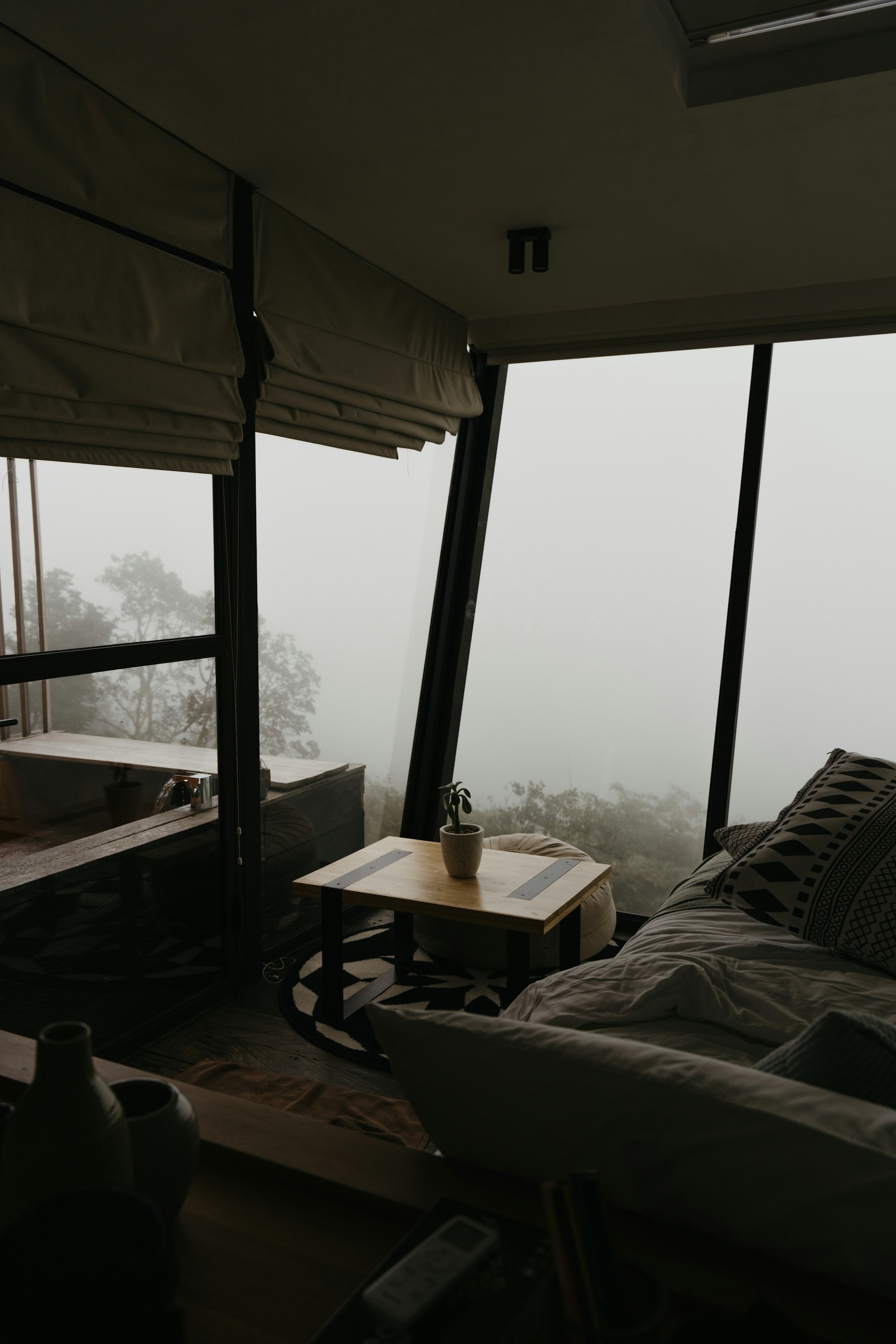 A living room filled with furniture and tall windows