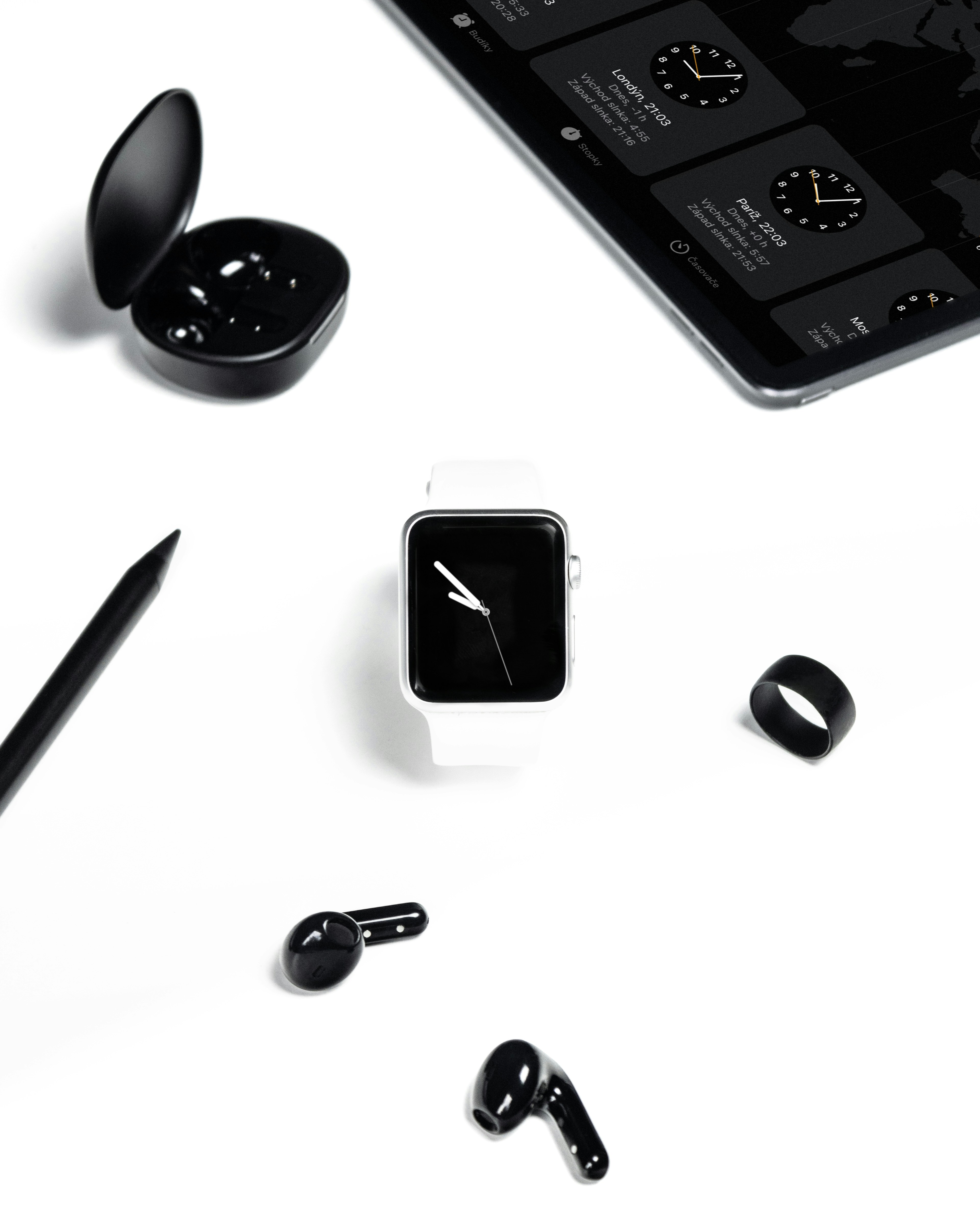 A white table topped with electronics and a cell phone