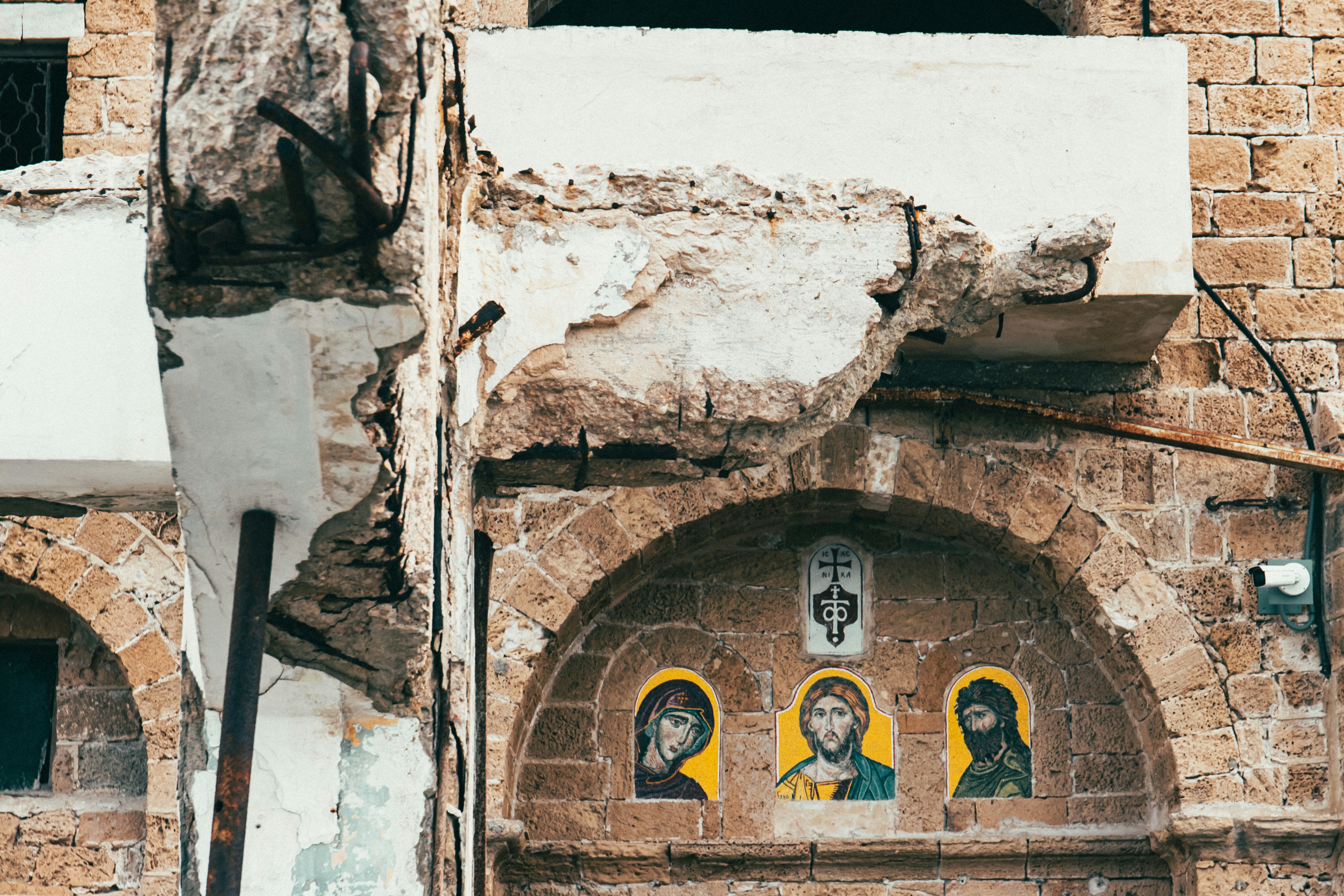 A building with a bunch of paintings on the side of it