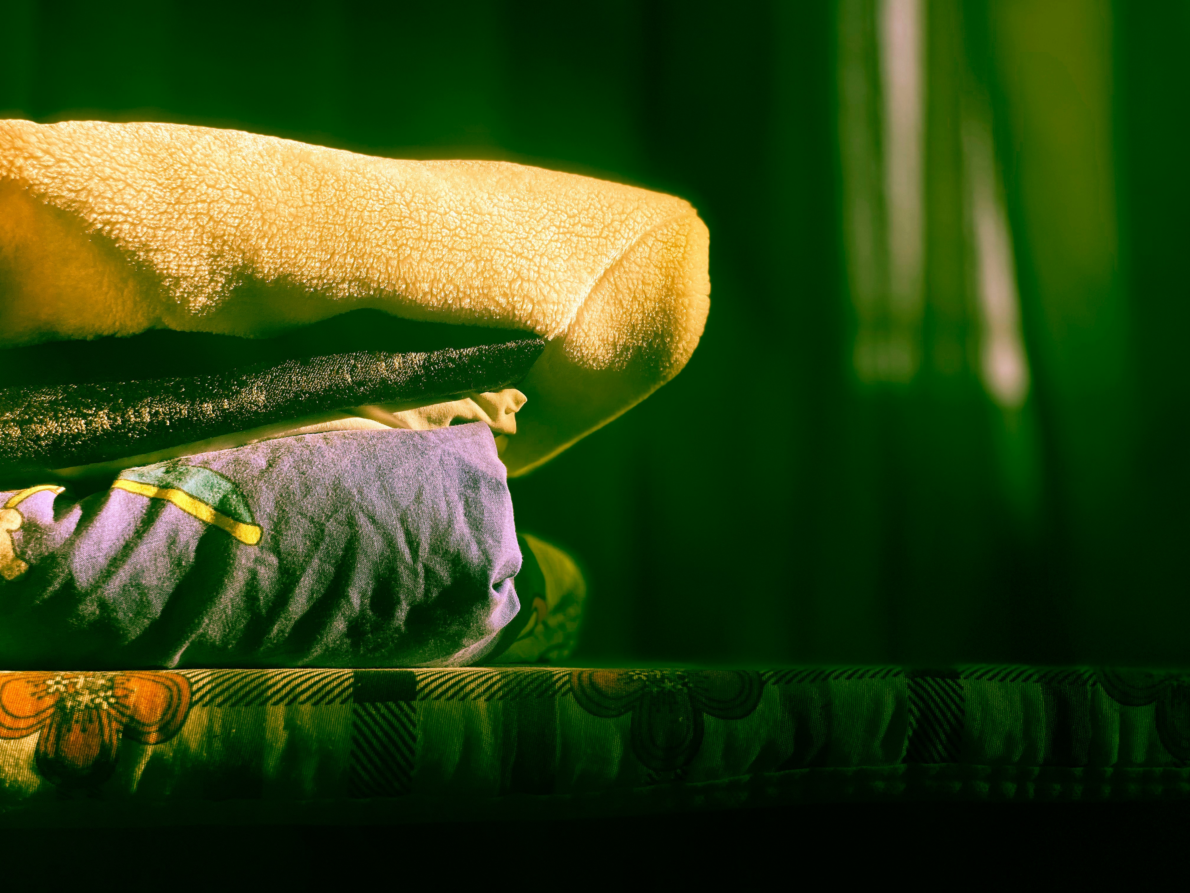 A pile of folded clothes sitting on top of a table