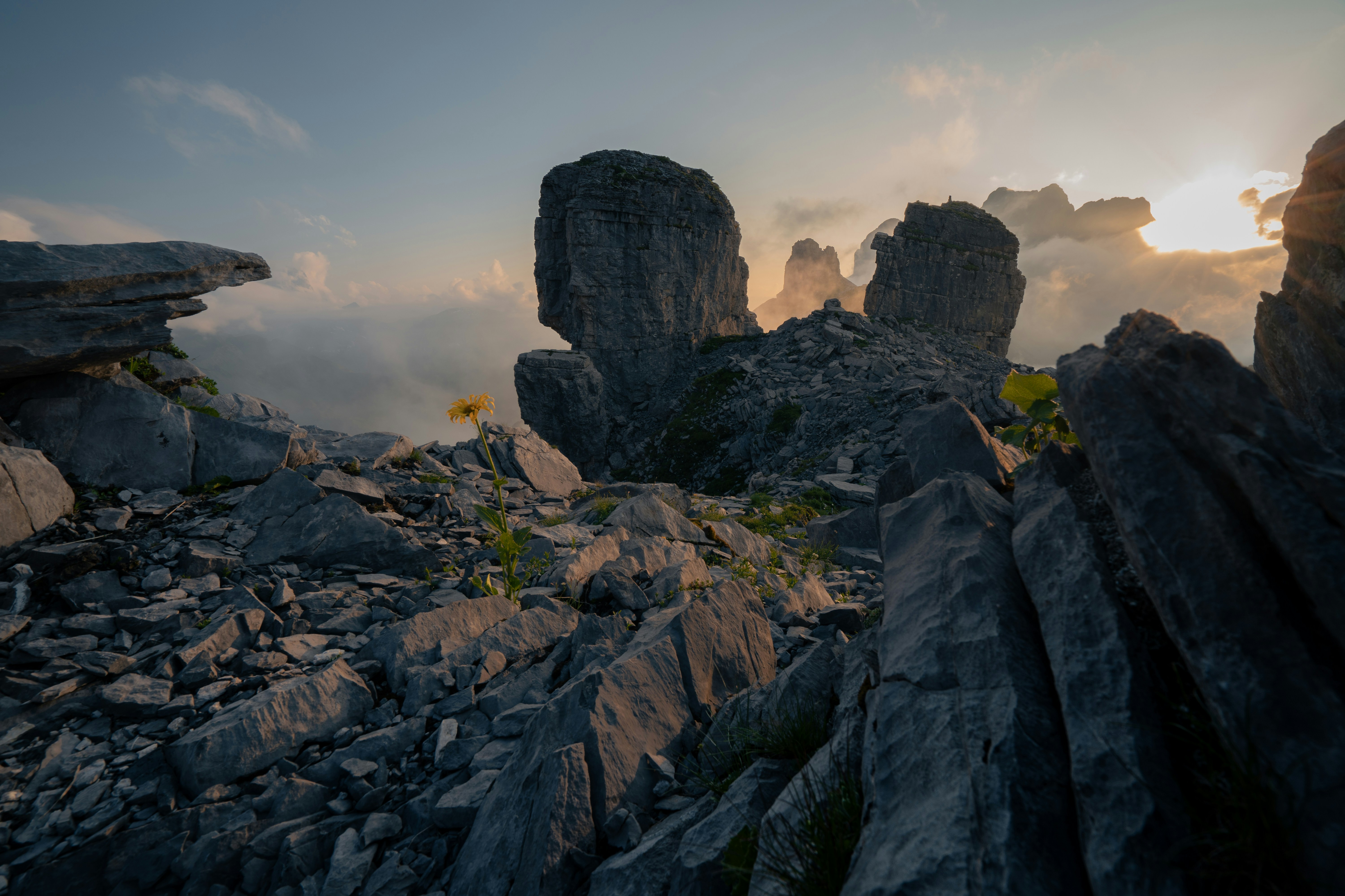 The sun is setting over the rocky terrain photo – Free Switzerland ...