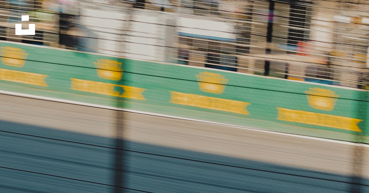 Two race cars racing on a track with spectators watching photo – Free ...