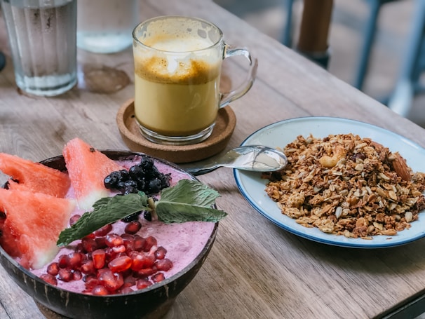 A wooden table topped with plates of food