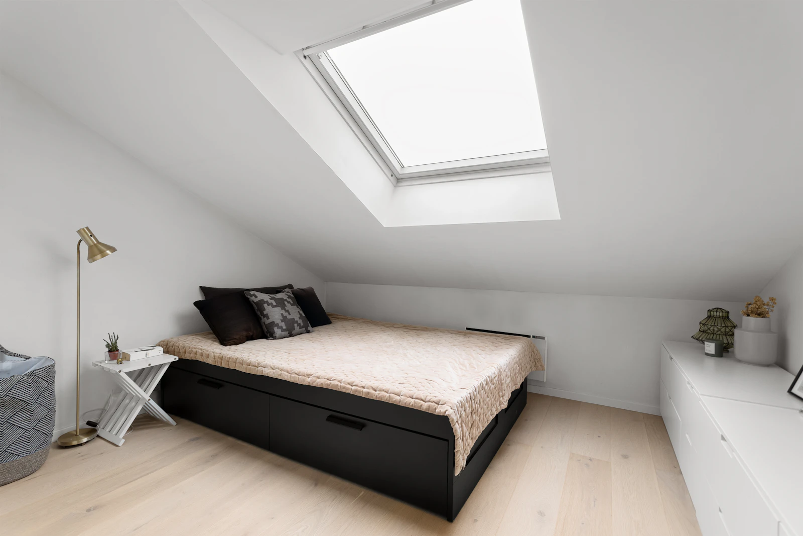 Loft bedroom with a roof window above the bed