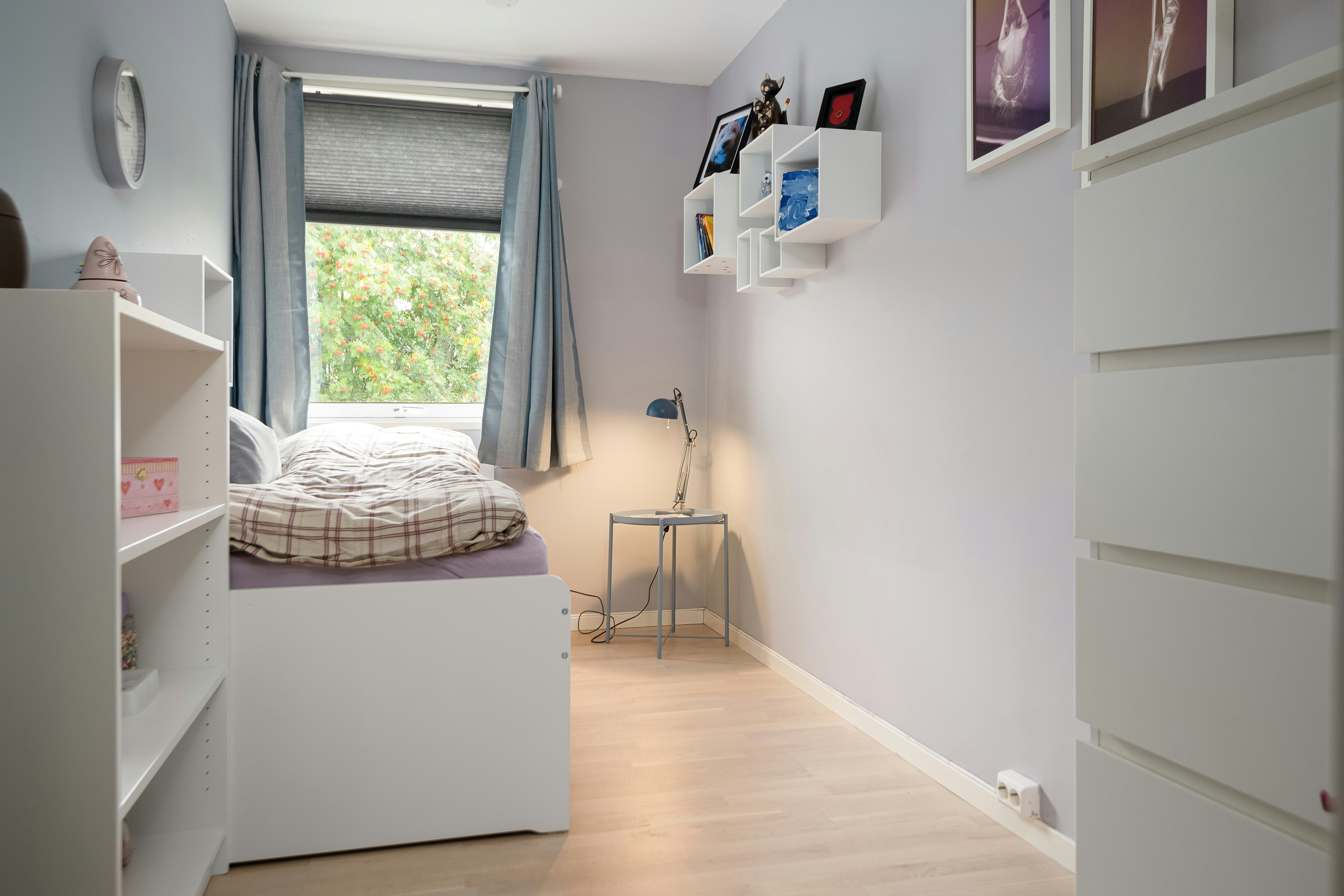 A bedroom with a bed and a desk in it