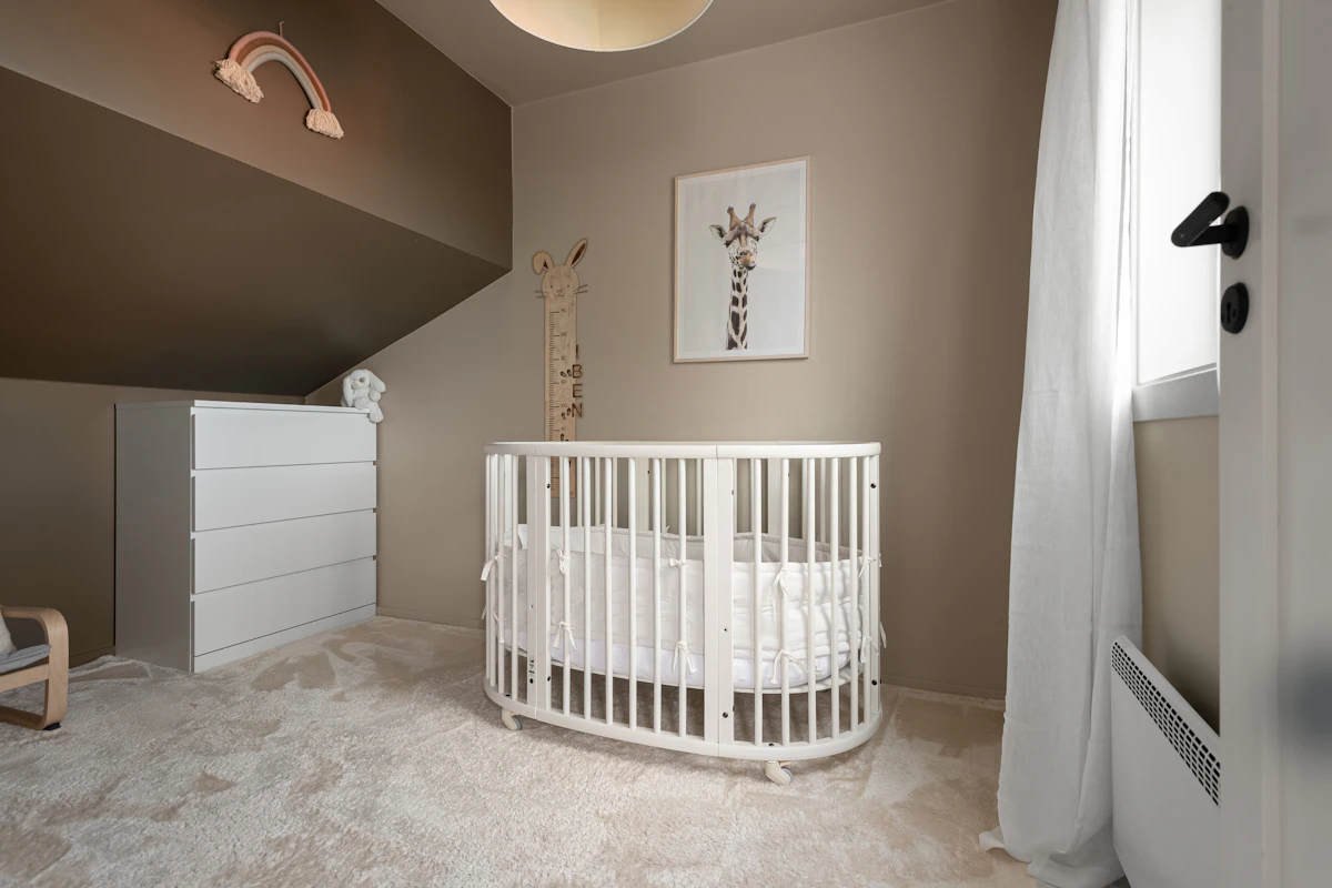 A baby's room featuring a crib and a rocking chair