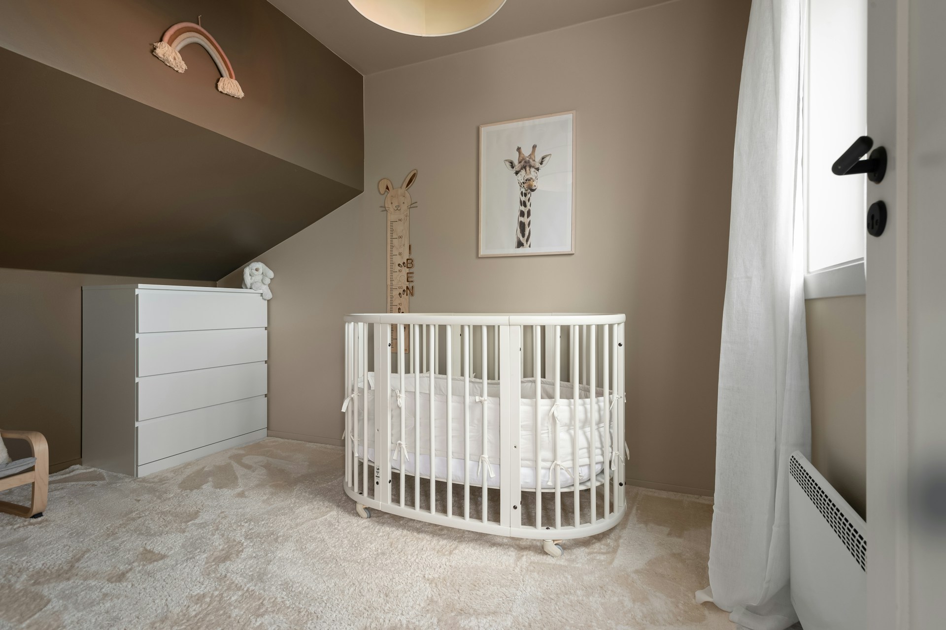 A baby's room with a crib and a rocking chair