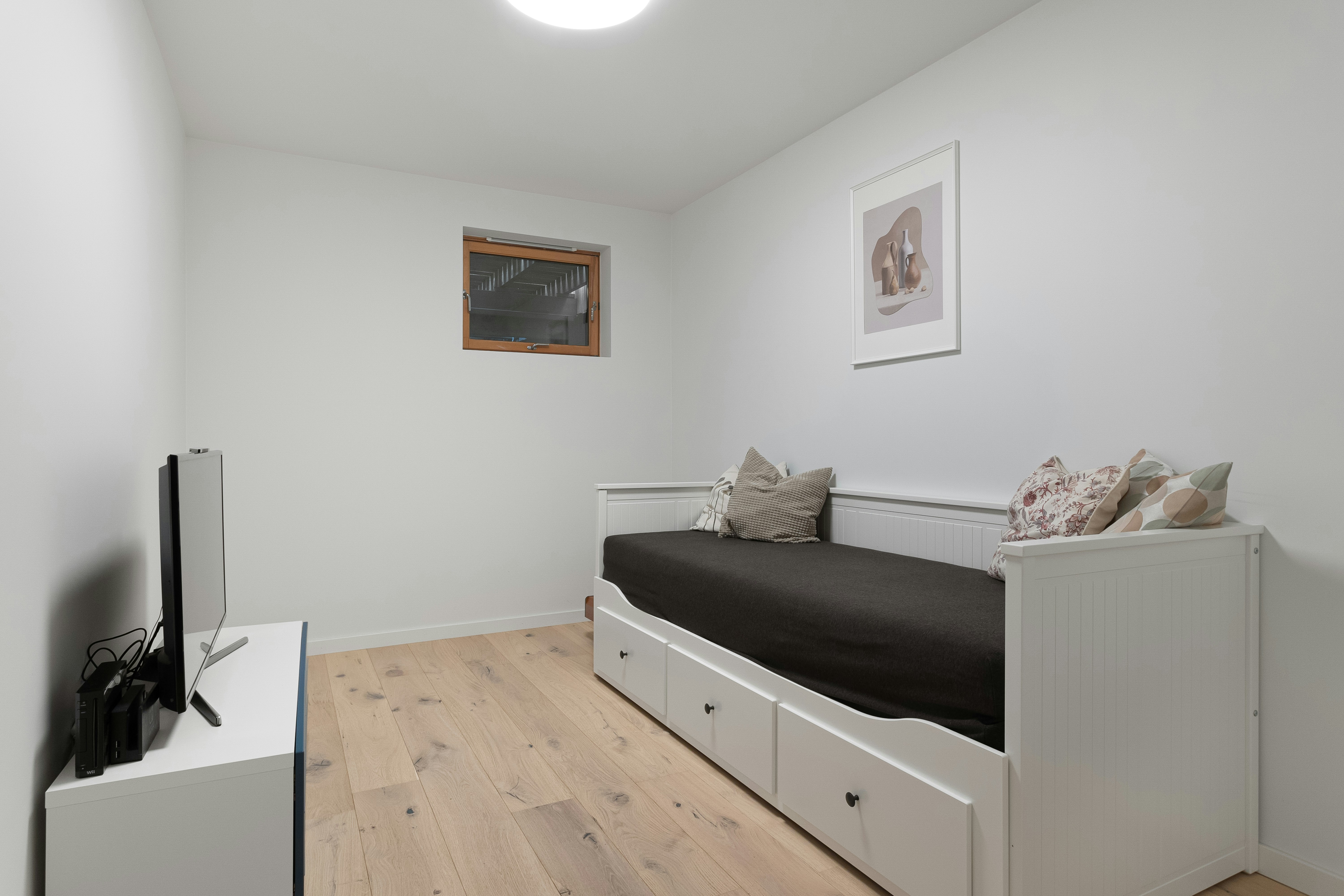 A bedroom with a bed and a television in it