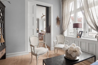 A living room filled with furniture and a large window