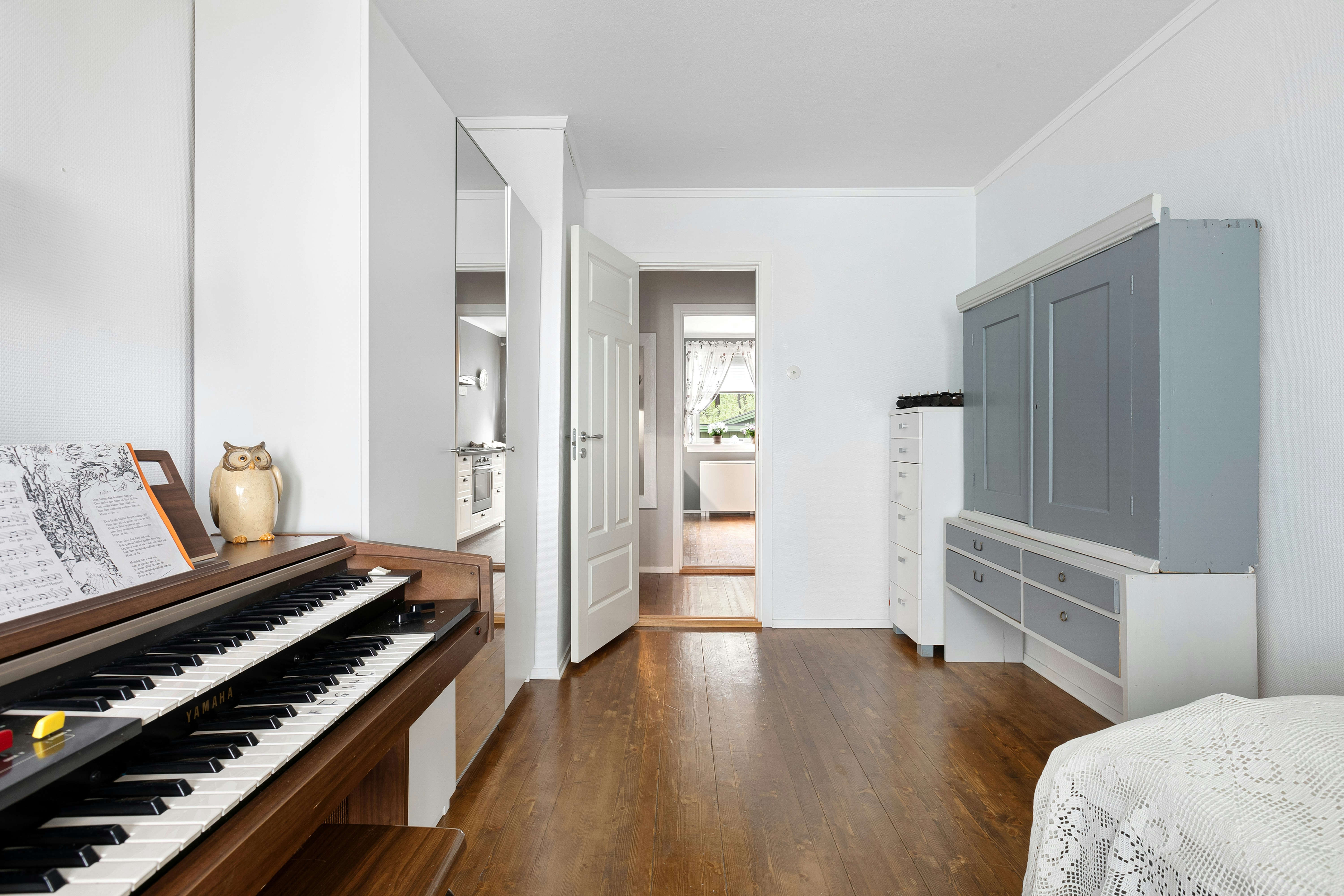 A living room filled with furniture and a piano