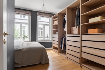A bedroom with a bed and a closet
