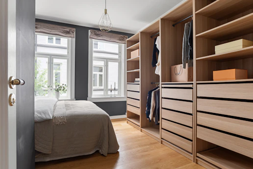 A bedroom with a bed and a closet