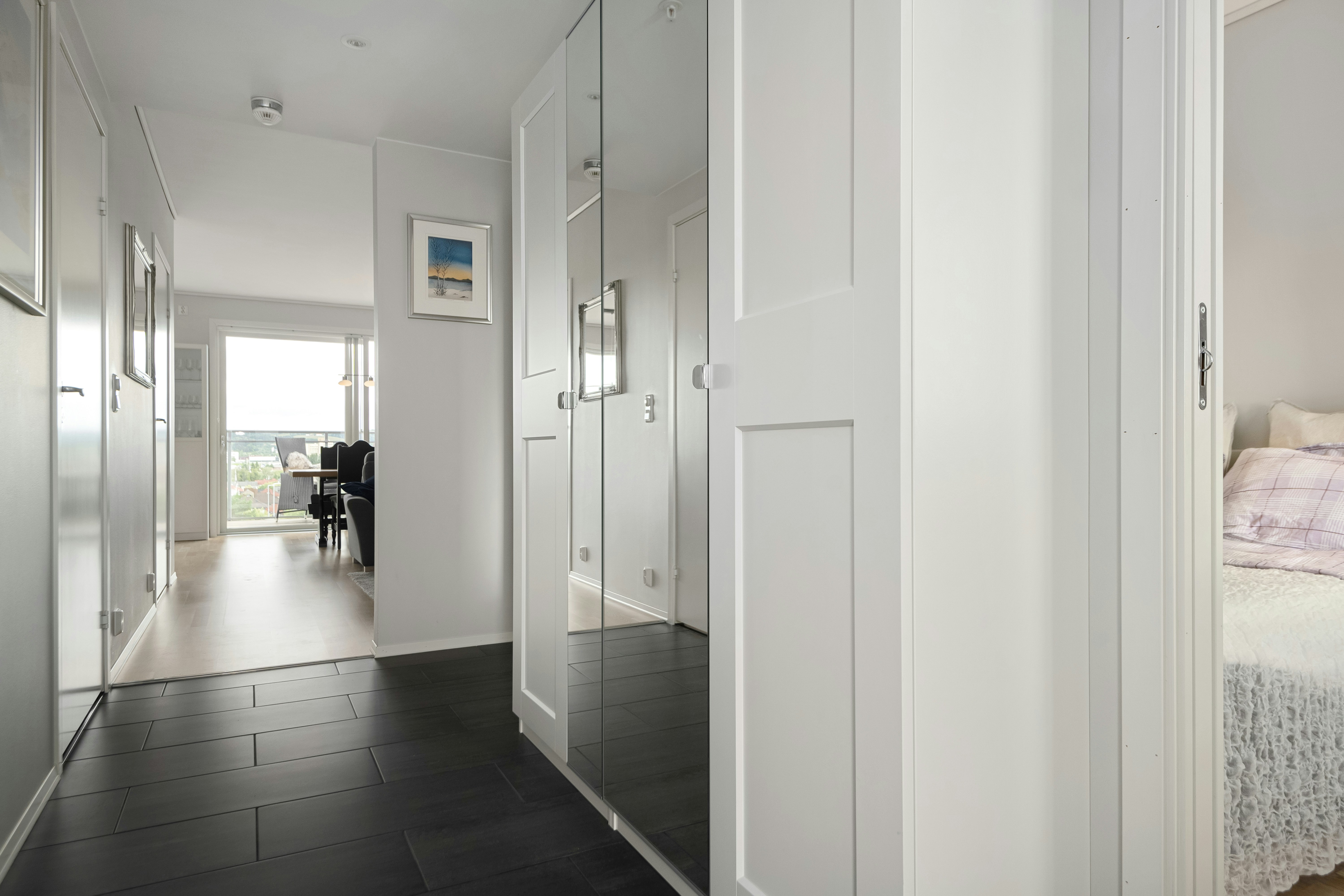 A bedroom with a bed and a mirror on the wall
