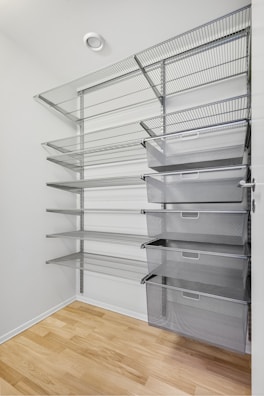 A walk in closet filled with lots of shelves