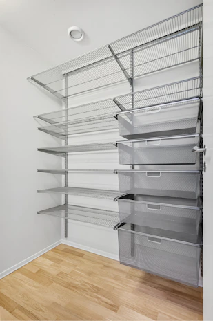 A walk in closet filled with lots of shelves