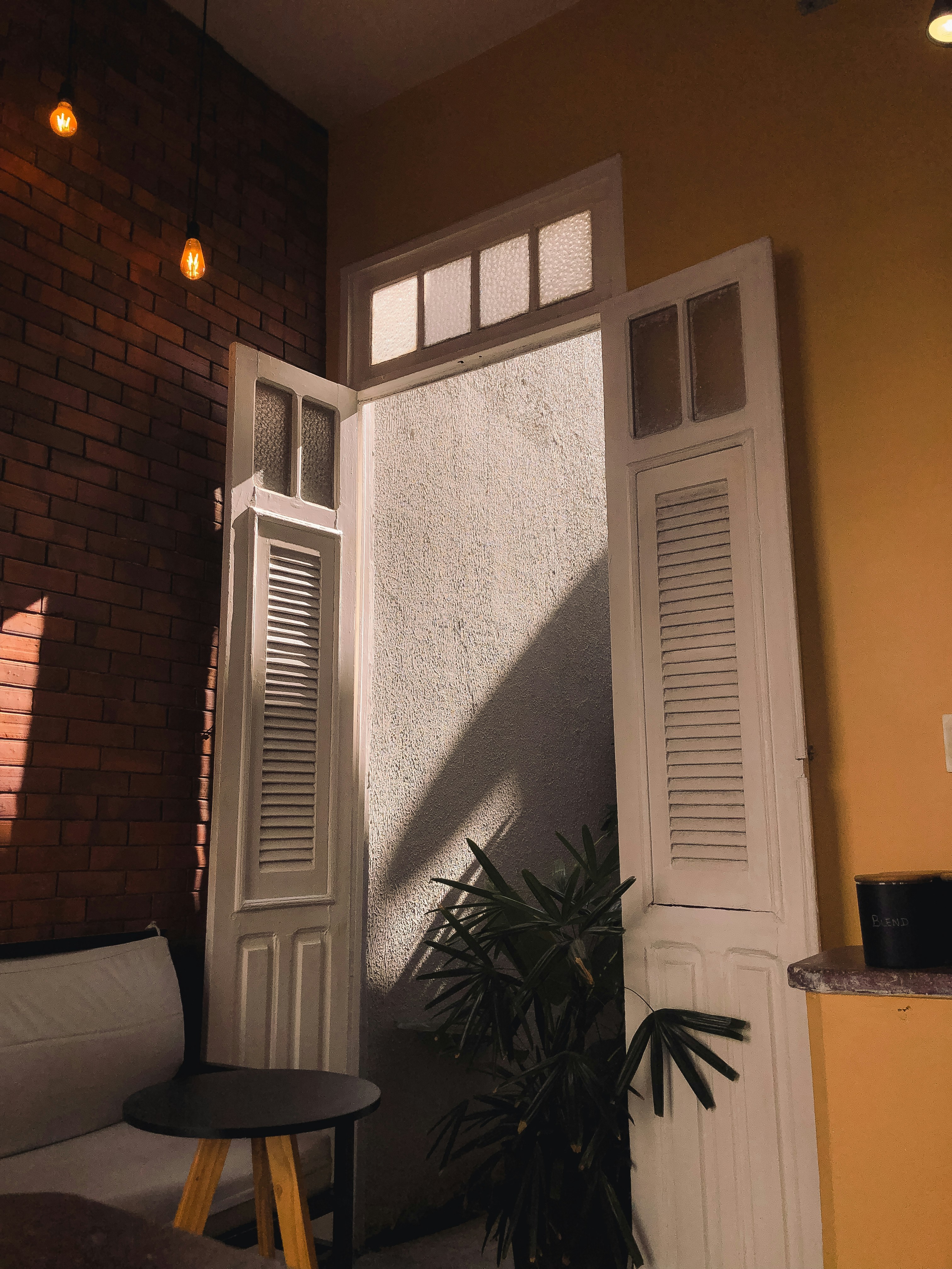 A living room filled with furniture and a brick wall