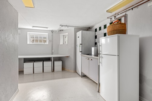 A white refrigerator freezer sitting inside of a kitchen