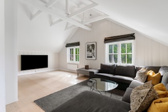 A living room with a couch a table and a TV