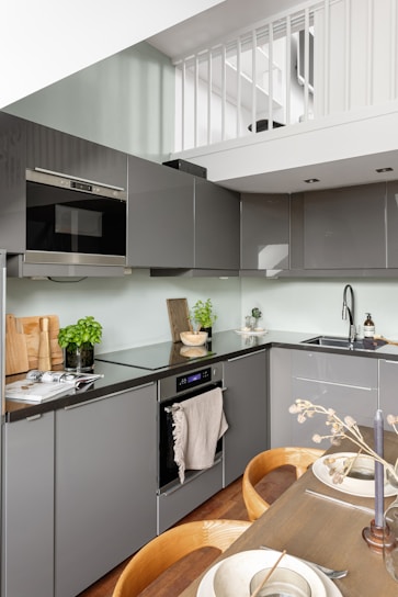 A kitchen that has a table and chairs in it