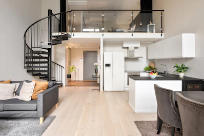 A living room filled with furniture and a spiral staircase