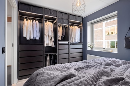 A bedroom with a bed and a closet