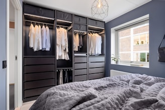 A bedroom with a bed and a closet