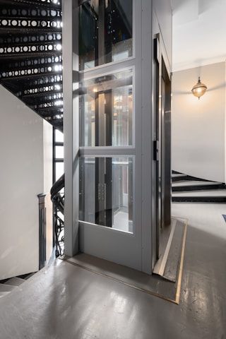A staircase with a glass door leading up to it