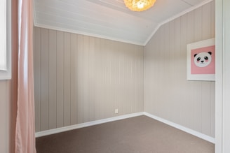 A room with a ceiling fan and a window