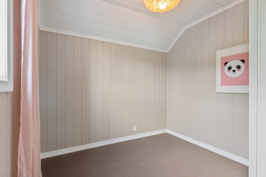 A room with a ceiling fan and a window