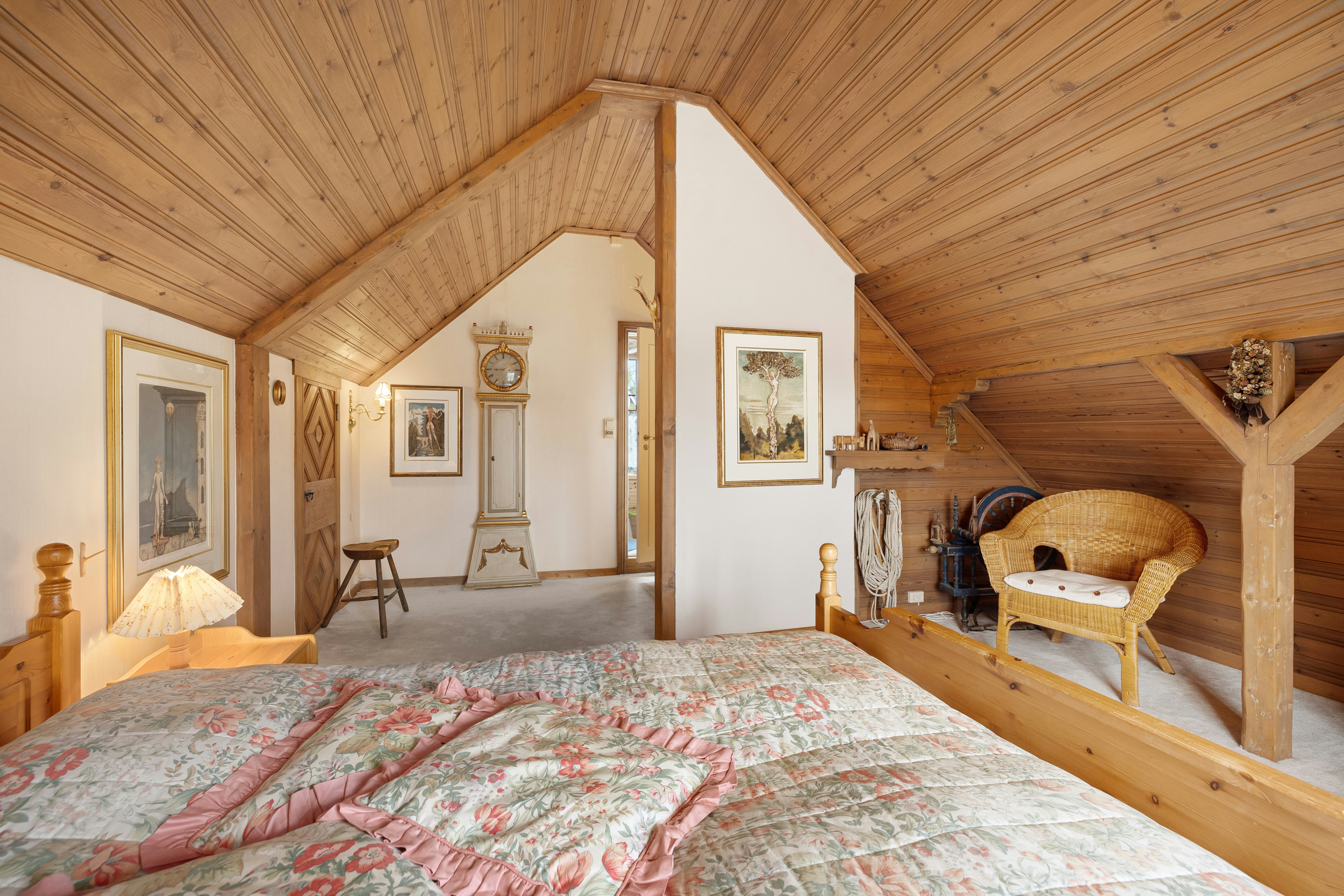 a bedroom with a large bed and wooden walls