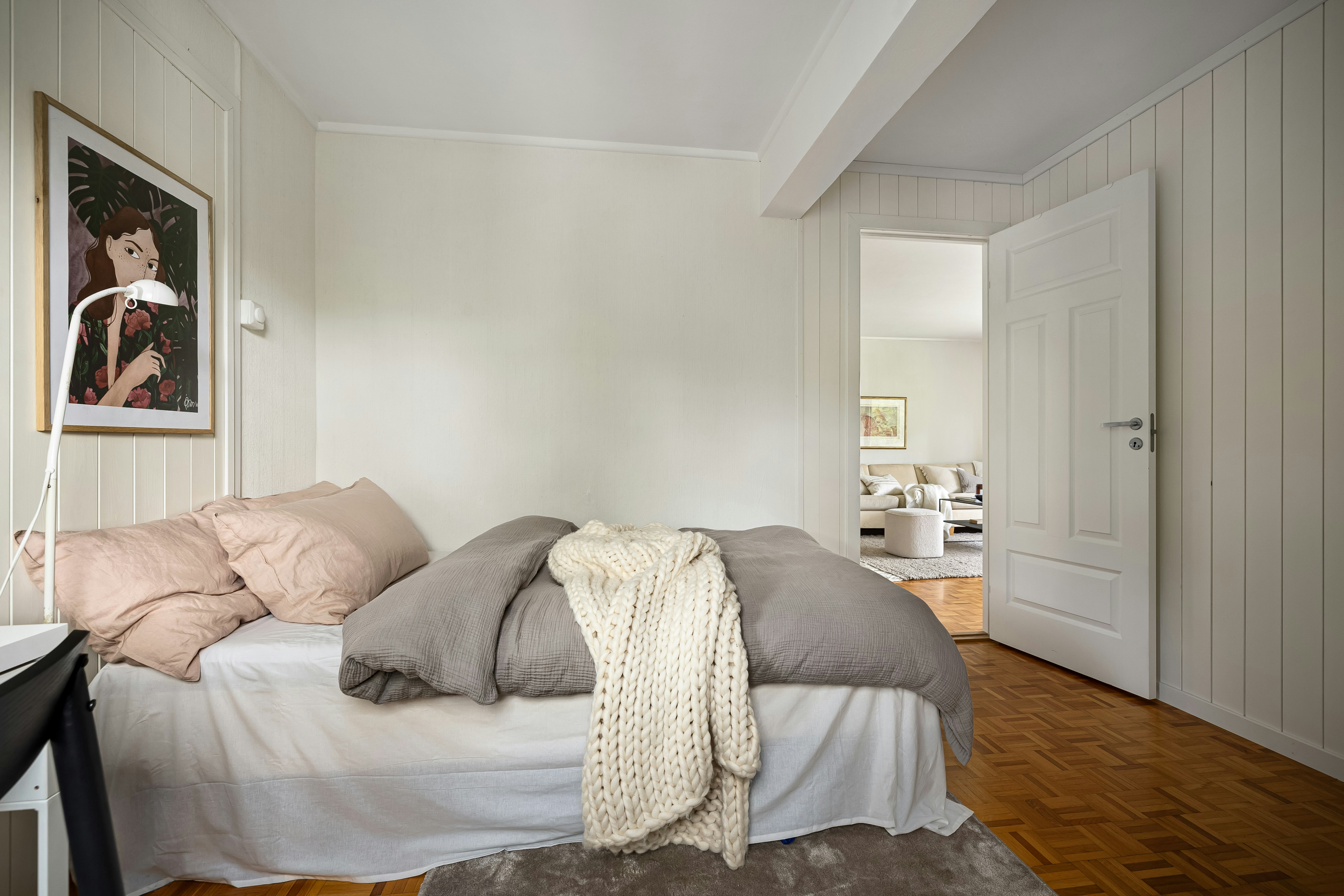 A bedroom with a bed and a desk