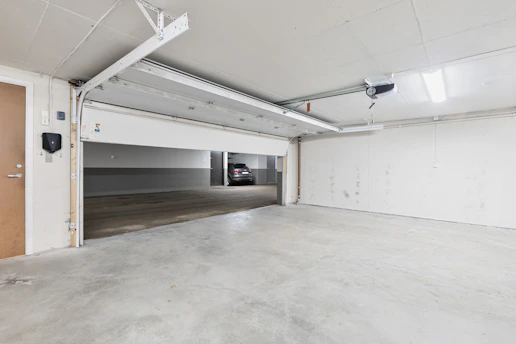 An empty parking garage with a door open