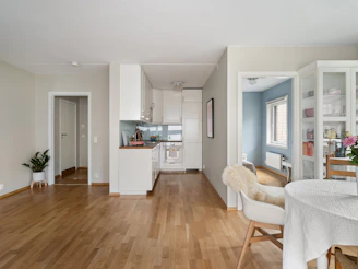 A living room filled with furniture and a dining room table