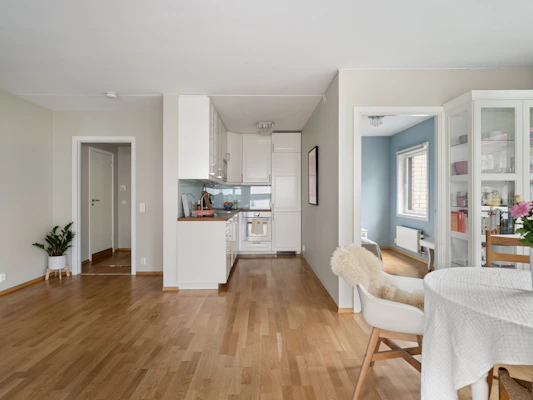 A living room filled with furniture and a dining room table