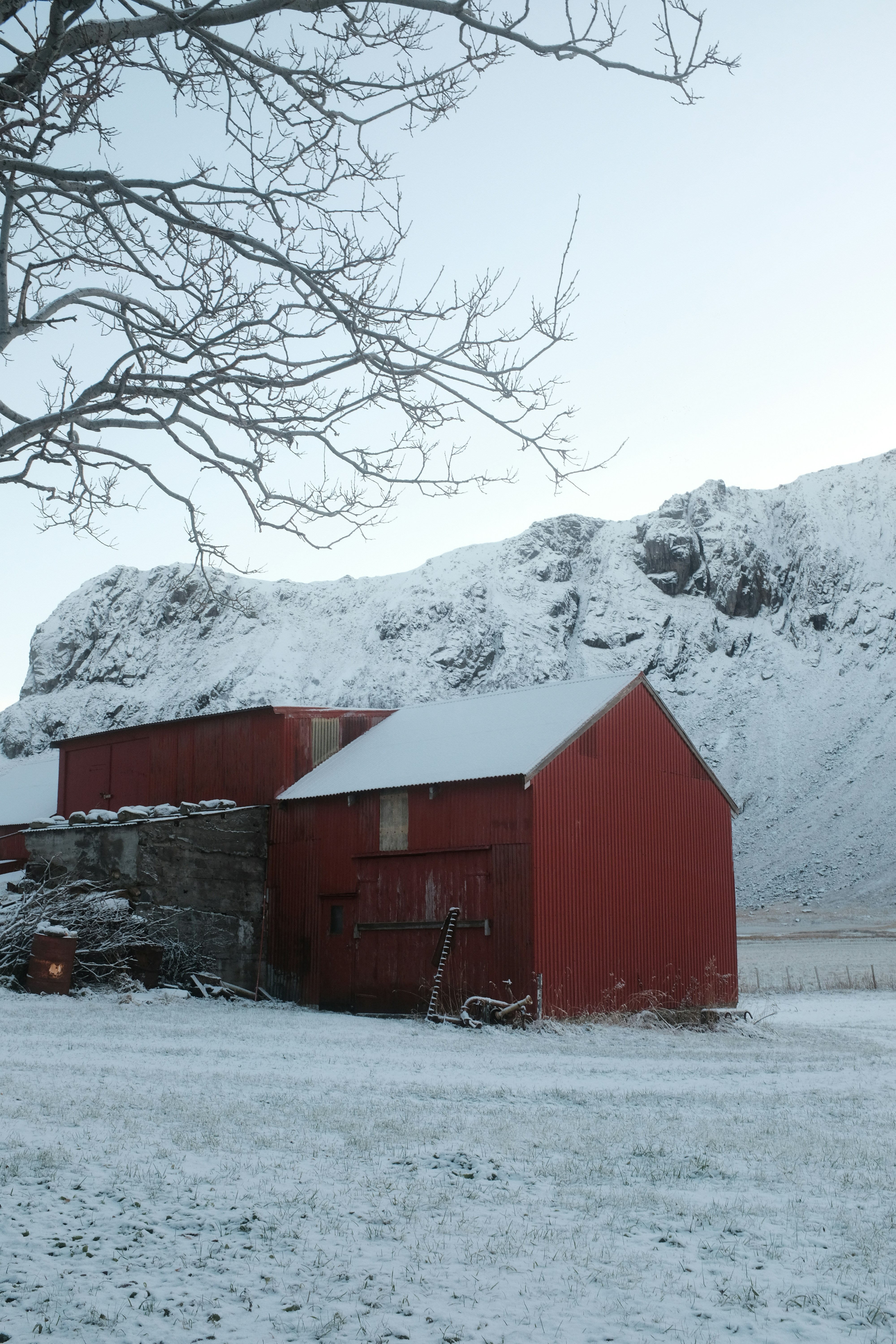 A red barn in the middle of a snowy field