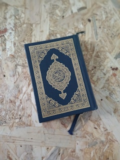 A blue book sitting on top of a wooden floor
