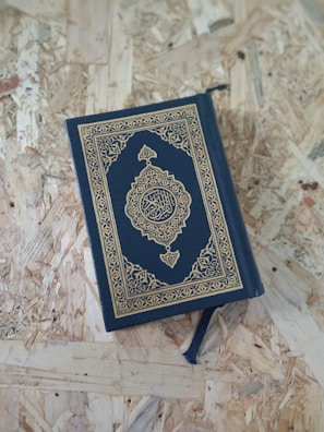 A blue book sitting on top of a wooden floor