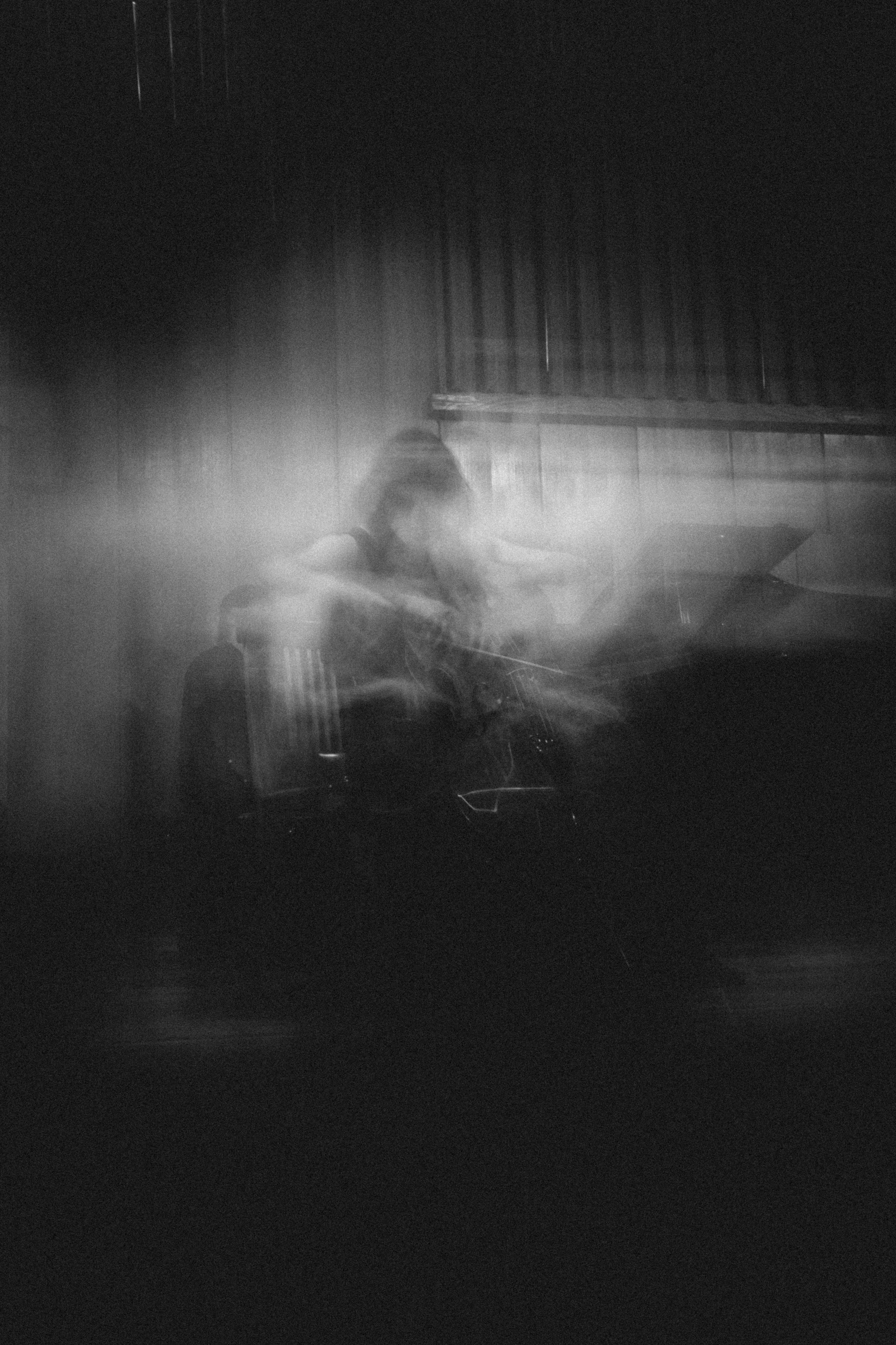 A blurry photo of a person sitting in a chair