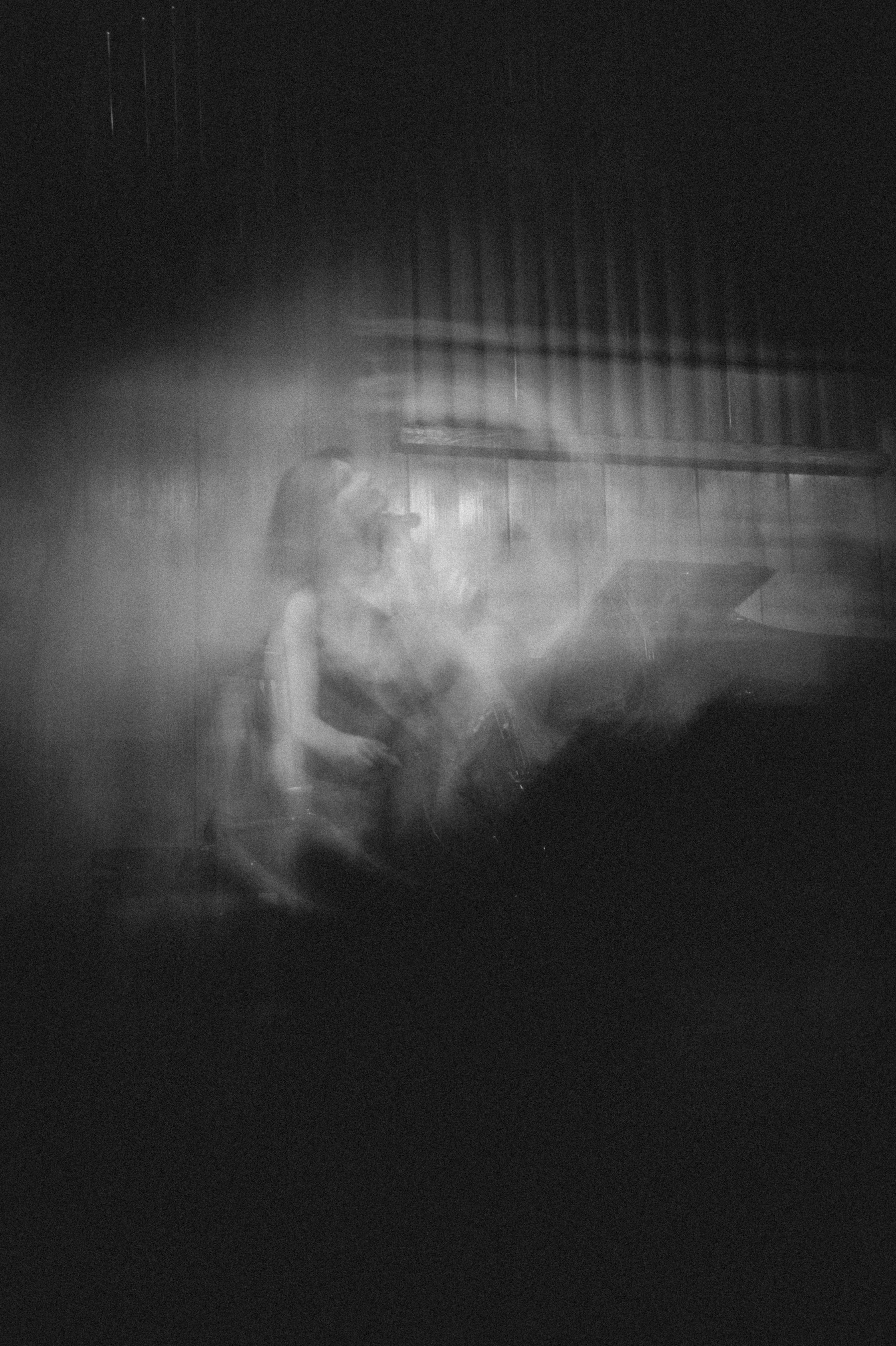 A blurry image of a person sitting in a chair