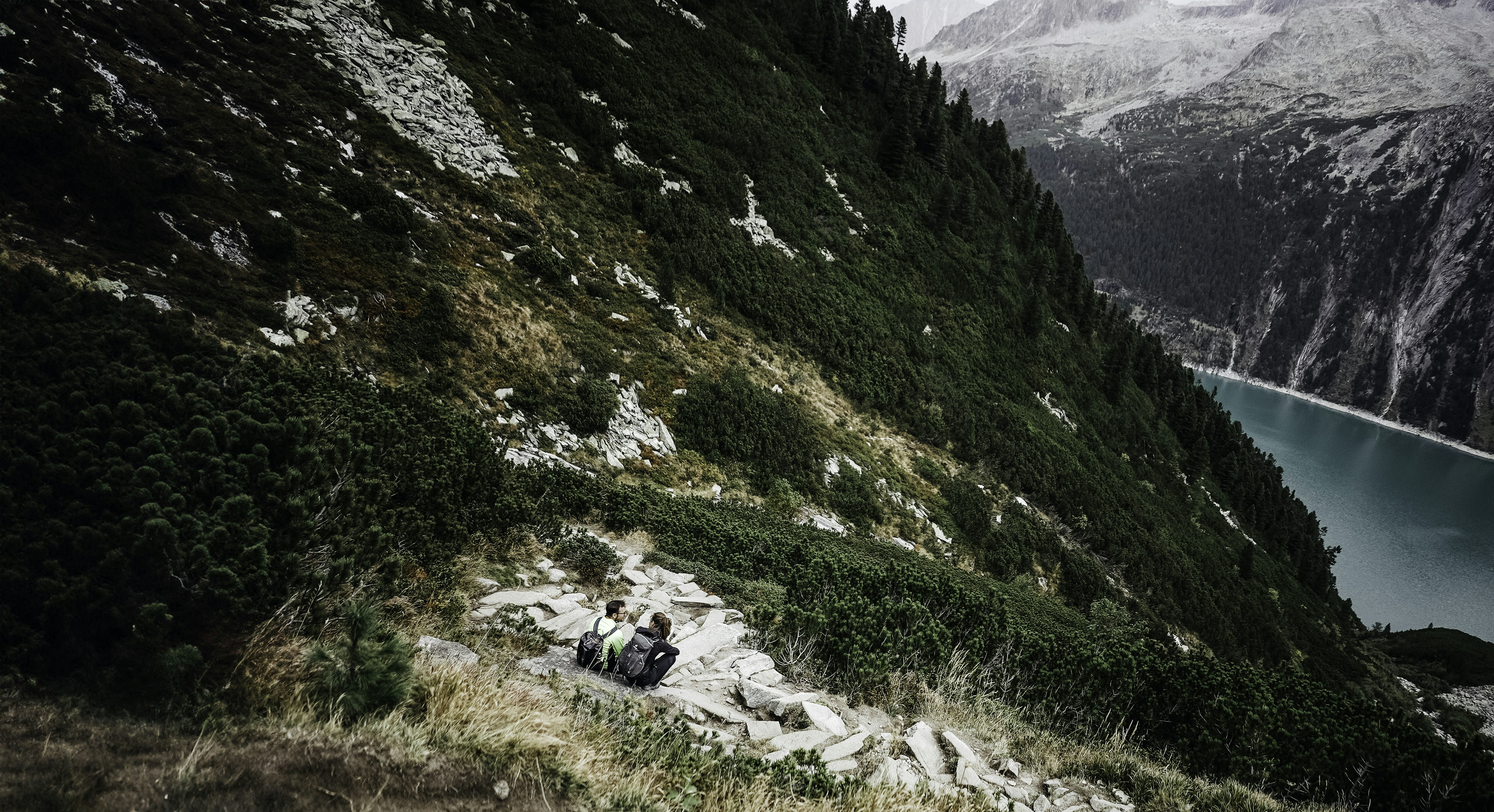 A man riding a snowmobile down a snow covered slope