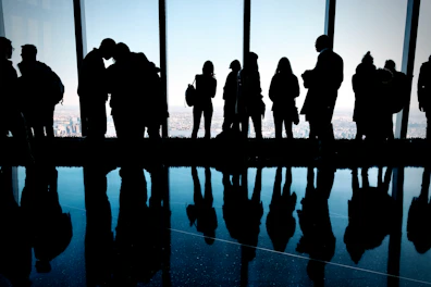 A group of people standing in front of a window