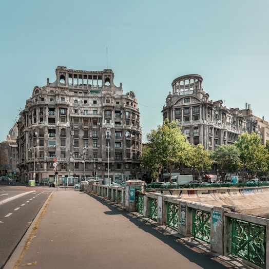 A city street lined with tall buildings next to a bridge