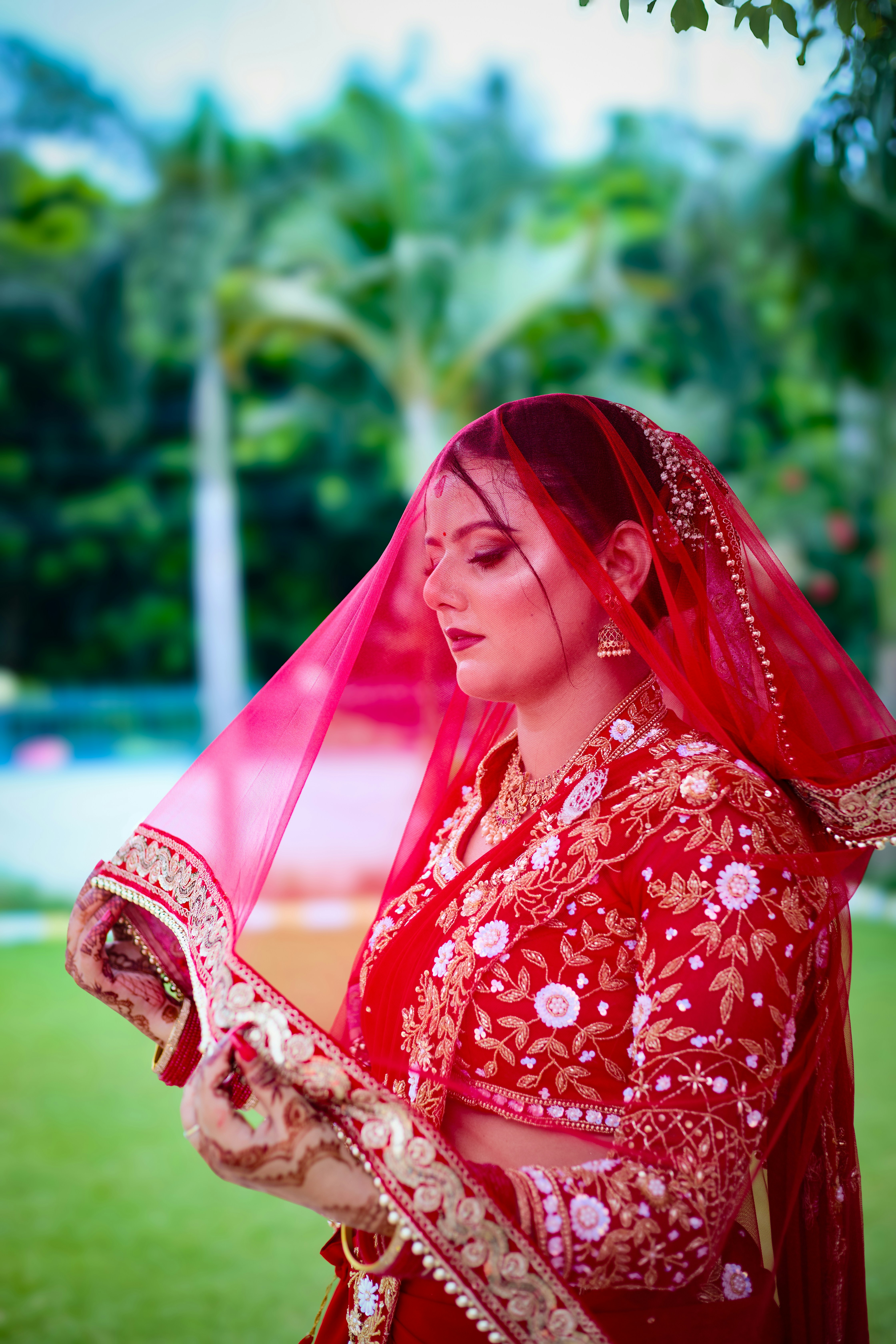 A woman in a red and gold bridal outfit